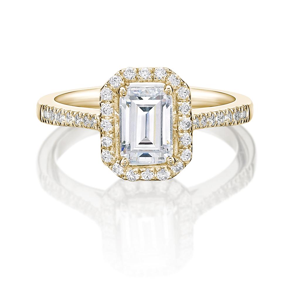 Emerald Cut and Round Brilliant halo engagement ring with 1.29 carats* of diamond simulants in 14 carat yellow gold
