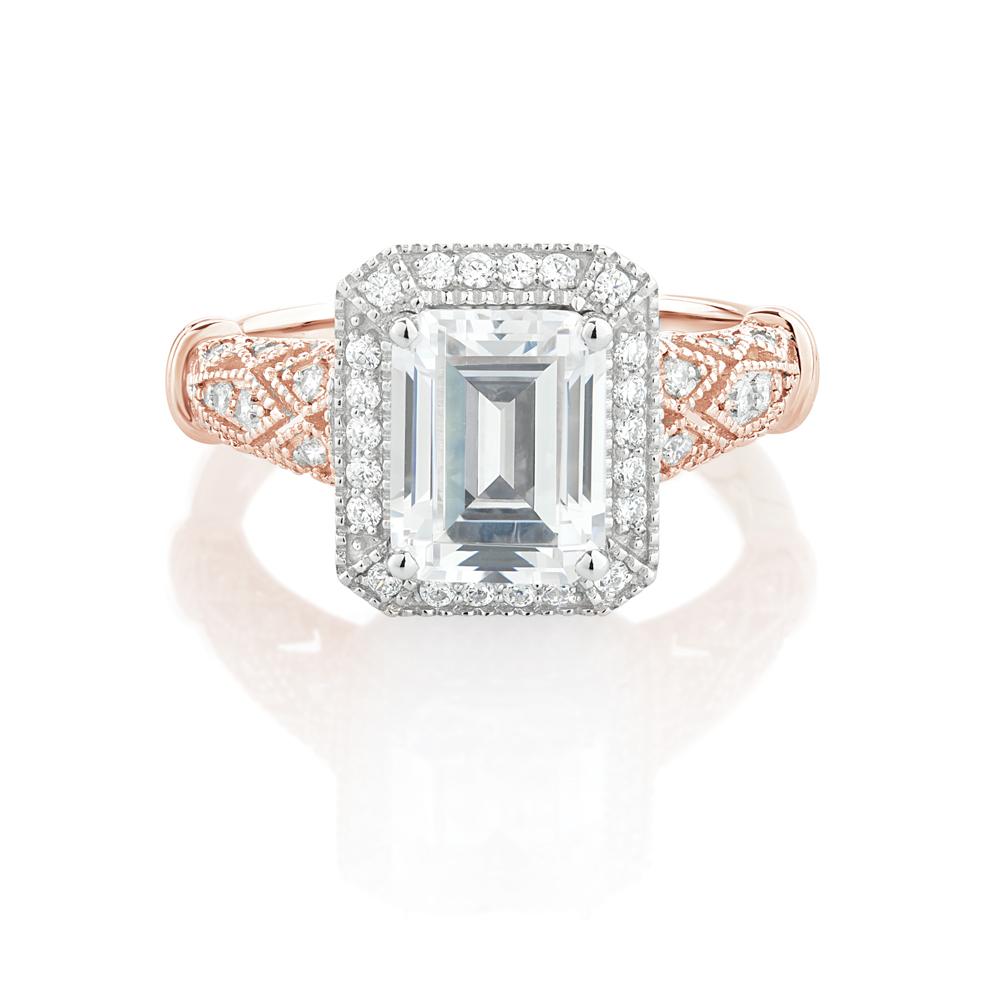 Emerald Cut and Round Brilliant halo engagement ring with 2.9 carats* of diamond simulants in 10 carat rose and white gold