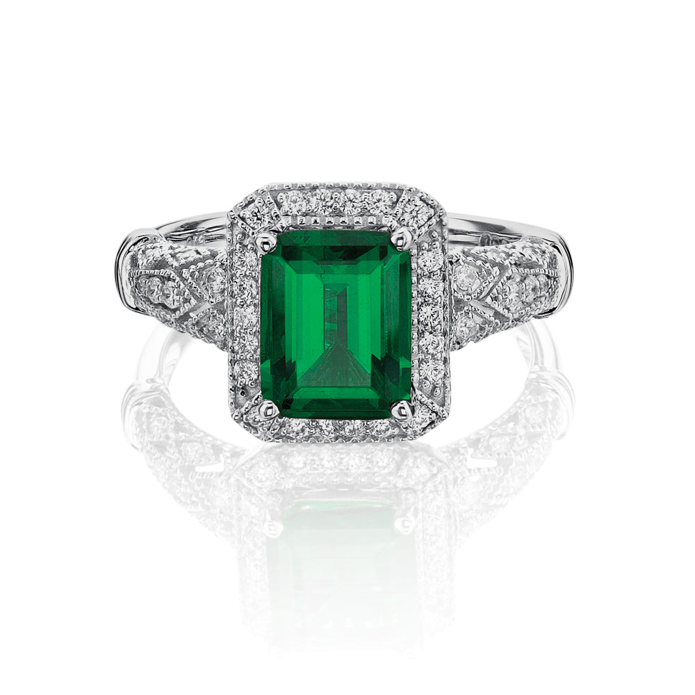 Dress ring with 9x7mm emerald simulant and 0.27 carats* of diamond simulants in 10 carat white gold