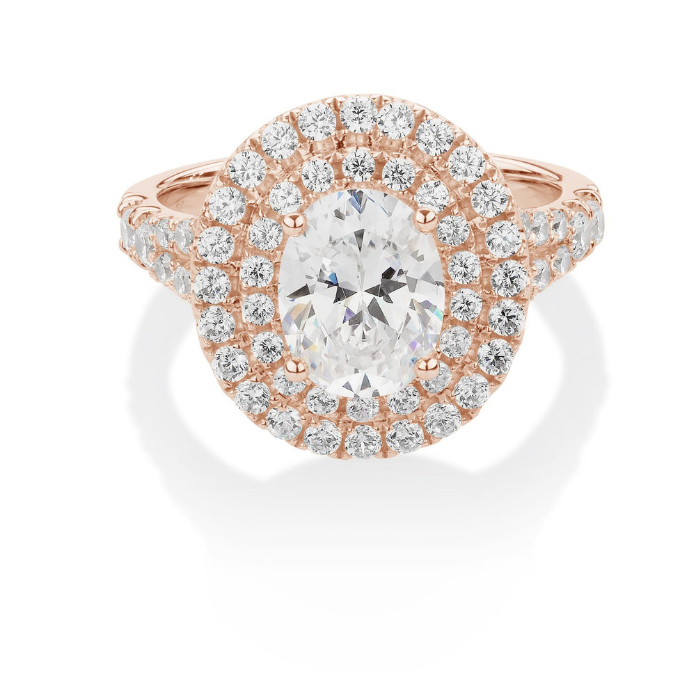 Oval and Round Brilliant halo engagement ring with 2.76 carats* of diamond simulants in 10 carat rose gold
