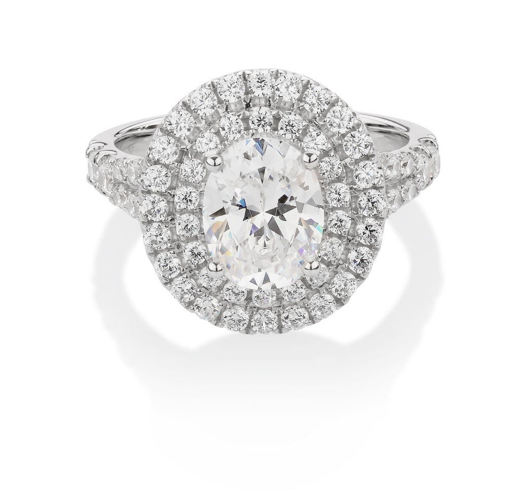 Oval and Round Brilliant halo engagement ring with 2.76 carats* of diamond simulants in 10 carat white gold