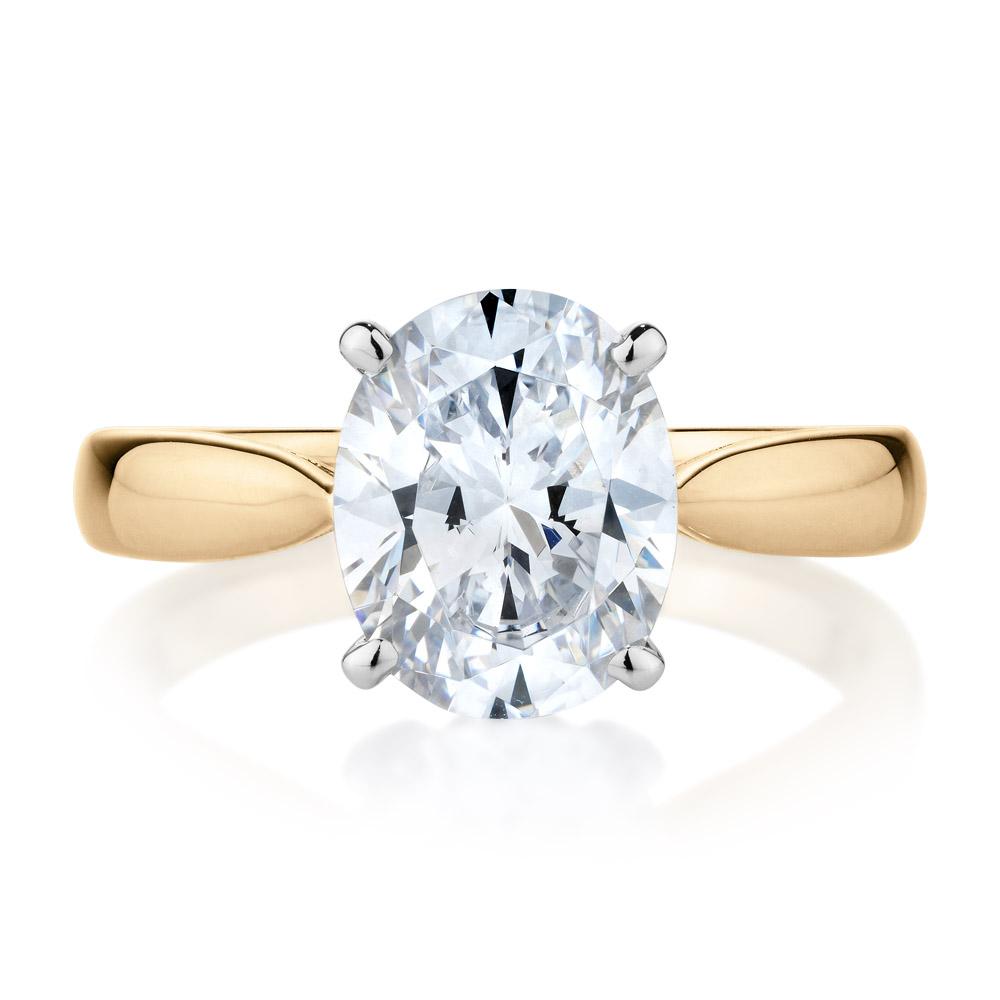 Oval solitaire engagement ring with 2.54 carat* diamond simulant in 14 carat yellow and white gold