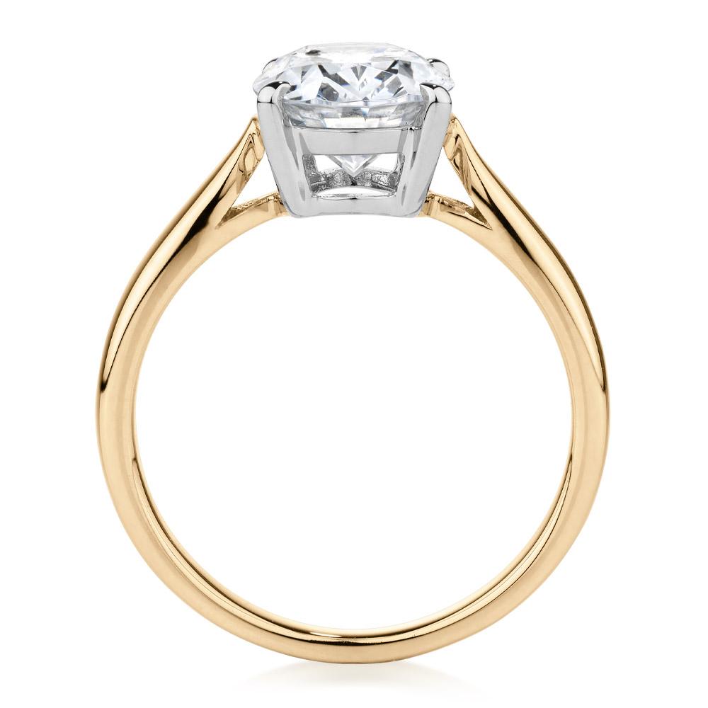 Oval solitaire engagement ring with 2.54 carat* diamond simulant in 14 carat yellow and white gold